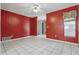 Spacious living area featuring tile floors, a bright red accent wall, and lots of natural light at 1017 Manchester Cir, Winter Park, FL 32792