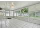 This sunroom is well-lit with many windows and white tile at 1017 Manchester Cir, Winter Park, FL 32792