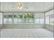 Bright sunroom with tile floors and large windows offering abundant natural light and a view of the outdoors at 1017 Manchester Cir, Winter Park, FL 32792