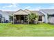 Lush backyard showcasing a screened lanai, well-maintained lawn, and tropical landscaping for outdoor enjoyment at 116 Candlewick Ct, Sanford, FL 32771