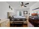 Comfortable bedroom featuring wood floors, a ceiling fan, and an ensuite bathroom at 116 Candlewick Ct, Sanford, FL 32771