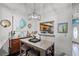 Cozy dining area featuring a modern light fixture, stylish decor, and a convenient pass-through to the kitchen at 116 Candlewick Ct, Sanford, FL 32771