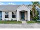 Inviting home exterior featuring a stucco facade, blue door, and lush landscaping at 116 Candlewick Ct, Sanford, FL 32771