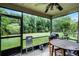Relaxing screened porch with views of a lush backyard and a serene pond at 116 Candlewick Ct, Sanford, FL 32771