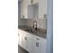 Kitchen with granite counters, stainless steel sink, modern faucet, and white cabinets at 1212 Leon Ln, Daytona Beach, FL 32117