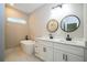 Luxurious bathroom showcasing double vanities, modern fixtures, and a freestanding soaking tub with natural light at 1331 19Th St, Orlando, FL 32805