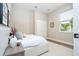 A clean bedroom with a white platform bed, closet, and window offering natural light at 1331 19Th St, Orlando, FL 32805