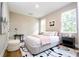 Serene primary bedroom with neutral tones, plush rug, and abundant natural light from the large windows at 1331 19Th St, Orlando, FL 32805