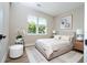 A beautifully staged bedroom with neutral tones and a view of the outdoors at 1331 19Th St, Orlando, FL 32805