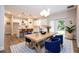 Open-concept dining area with modern lighting, a large dining table, and access to the kitchen at 1331 19Th St, Orlando, FL 32805