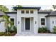 Striking front entrance with a gray front door, decorative lighting, and meticulous landscaping at 1331 19Th St, Orlando, FL 32805