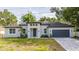 Beautifully renovated single-story home with a gray exterior, freshly landscaped yard, and a two-car garage at 1331 19Th St, Orlando, FL 32805