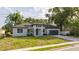 Beautiful single-story home featuring a gray exterior, lush landscaping, and an attached two-car garage at 1331 19Th St, Orlando, FL 32805
