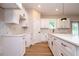 Modern white kitchen featuring stone countertops, white cabinets, new appliances, and recessed lighting at 1331 19Th St, Orlando, FL 32805