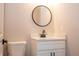 Close-up of a powder room boasting a sleek vanity, round mirror, and modern design elements at 1331 19Th St, Orlando, FL 32805