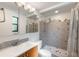 Updated bathroom with gray tiled shower, modern fixtures, and decorative black accents at 1343 Charlotte St, Altamonte Springs, FL 32701
