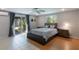 Bright bedroom features a ceiling fan, light gray walls, and sliding doors to the outside at 1343 Charlotte St, Altamonte Springs, FL 32701