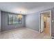 A naturally lit dining room with tiled floors, a hanging lamp, and a door to another room at 1343 Charlotte St, Altamonte Springs, FL 32701