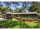 Well-maintained house with a stone facade, mature landscaping, and a spacious front yard at 1343 Charlotte St, Altamonte Springs, FL 32701
