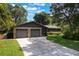 Charming home featuring a stone facade, two-car garage, and mature landscaping at 1343 Charlotte St, Altamonte Springs, FL 32701