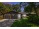 Charming single-story home featuring a stone-accented garage and lush, well-manicured landscaping at 1343 Charlotte St, Altamonte Springs, FL 32701