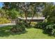 Charming single-story home featuring a lush front yard with mature trees and a well-manicured lawn at 1343 Charlotte St, Altamonte Springs, FL 32701