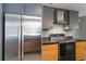 Modern kitchen showcasing stainless steel refrigerator and sleek range with natural wood finished cabinets at 1343 Charlotte St, Altamonte Springs, FL 32701