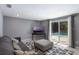 Bright living room with neutral colors, comfy seating, and a view of the sparkling pool through sliding glass doors at 1343 Charlotte St, Altamonte Springs, FL 32701