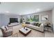 Bright living room with a comfortable couch, neutral decor, and large windows with natural lighting at 1343 Charlotte St, Altamonte Springs, FL 32701