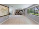 Bright living room with tile floors, large windows, and built-in bookshelf, creating a comfortable and inviting space at 1343 Charlotte St, Altamonte Springs, FL 32701