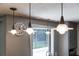 Modern pendant lights hang above a kitchen sink with views of the serene backyard and outdoor oasis at 1343 Charlotte St, Altamonte Springs, FL 32701