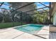 Relax by the screened-in pool, overlooking a lush green lawn shaded by mature trees, ideal for entertaining at 1343 Charlotte St, Altamonte Springs, FL 32701