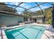 A refreshing in-ground pool area surrounded by a screened enclosure and a deck at 1343 Charlotte St, Altamonte Springs, FL 32701