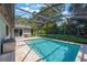 Enjoy the screened in pool, with travertine decking, which overlooks the lush green lawn and shady trees at 1343 Charlotte St, Altamonte Springs, FL 32701