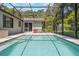 Inviting pool in screened enclosure, perfect for relaxation and outdoor entertainment. Lush landscaping provides privacy at 1343 Charlotte St, Altamonte Springs, FL 32701