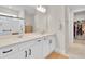 Bathroom with double sink, white cabinets and drawers, shower and a walk-in closet at 1425 Lone Wood Blvd, Orlando, FL 32828