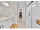 Bathroom featuring a walk-in closet, double vanity, and large glass shower with seat at 1425 Lone Wood Blvd, Orlando, FL 32828