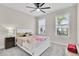 Comfortable bedroom with carpet, ceiling fan, and plantation shutters at 1425 Lone Wood Blvd, Orlando, FL 32828