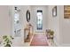 Bright foyer featuring tile floors, a decorative mirror, and a decorative front door at 1425 Lone Wood Blvd, Orlando, FL 32828