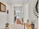 Neutral hallway with tile flooring and several decorative plants and furniture at 1425 Lone Wood Blvd, Orlando, FL 32828