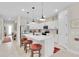 Modern kitchen featuring an island with bar stools, white cabinetry, and stainless appliances at 1425 Lone Wood Blvd, Orlando, FL 32828