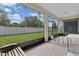 Covered lanai with brick pavers, view of the backyard, screened in enclosure and a ceiling light at 1425 Lone Wood Blvd, Orlando, FL 32828