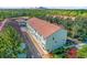 Elevated view of townhome buildings with manicured landscaping and convenient parking at 14501 Damai Ln, Orlando, FL 32821