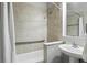 Neutral bathroom featuring shower/tub, tile surround, updated vanity and fixtures at 14501 Damai Ln, Orlando, FL 32821