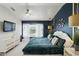 Chic bedroom with a window view, decorative wall details, and modern furniture at 14501 Damai Ln, Orlando, FL 32821