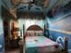 Themed bedroom with colorful mural, unique ceiling decor, and cozy furnishings at 14501 Damai Ln, Orlando, FL 32821