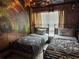 Themed bedroom featuring two twin beds, unique wall decor, and cozy furnishings at 14501 Damai Ln, Orlando, FL 32821