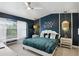 Stylish bedroom featuring a large bed, modern decor, and a bright window at 14501 Damai Ln, Orlando, FL 32821