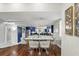 Bright dining room with a stylish table setting, hardwood floors, and an open view to the modern kitchen at 14501 Damai Ln, Orlando, FL 32821