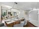 Bright dining room with modern chandelier, wood floors and a view to the living room at 14501 Damai Ln, Orlando, FL 32821